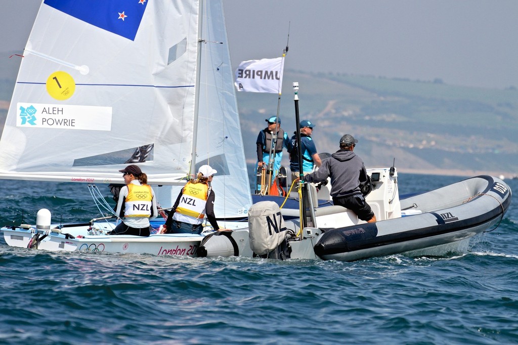 Coach Nathan Handley in a Lancer RIB with Jo Aleh and Olivia Powrie after their Gold Medal win in the 2012 Olympic Regatta, Weymouth © Richard Gladwell www.photosport.co.nz